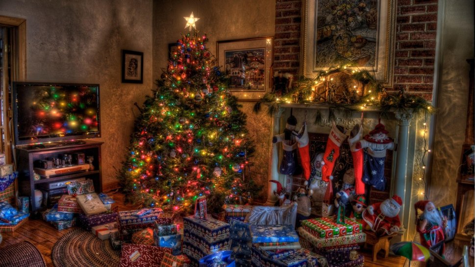 648097christmas_comfort_stockings_holiday_presents_tree_fireplace_background_wallpaper_imagep