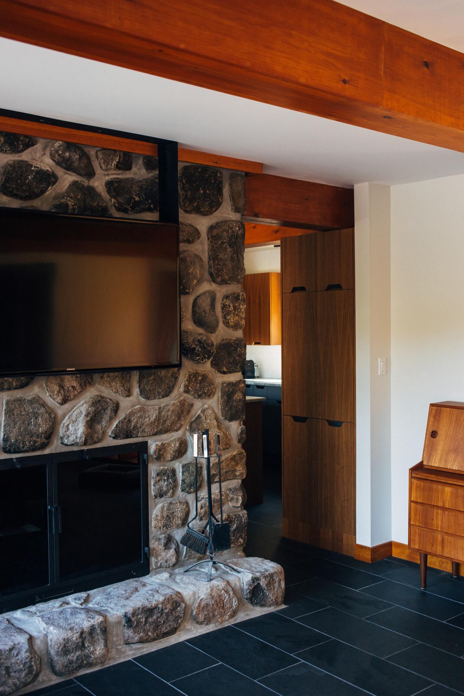 stone fireplace with TV above