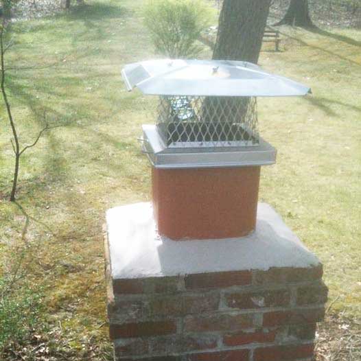 Lou Curley's Stainless Steel cap on single flue with screen to keep out debris, animals and water.